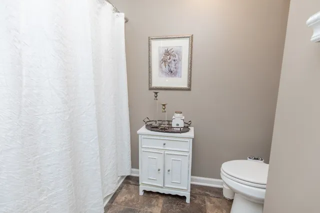 a bathroom with a toilet a sink and a window