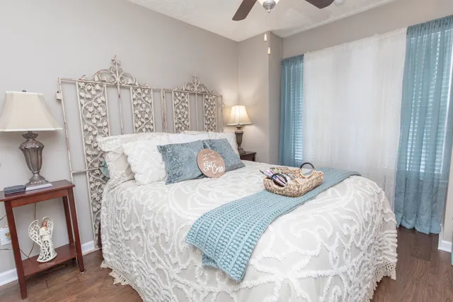 a bedroom with a bed and a night stand