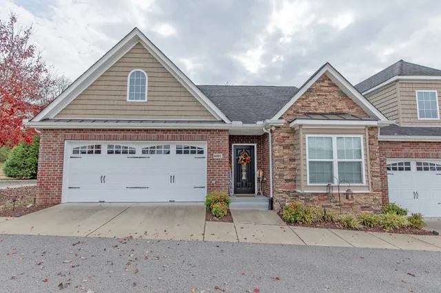 a view of a house with a yard and garage