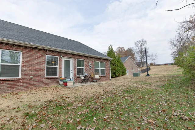 a view of a house with backyard sitting area and garden