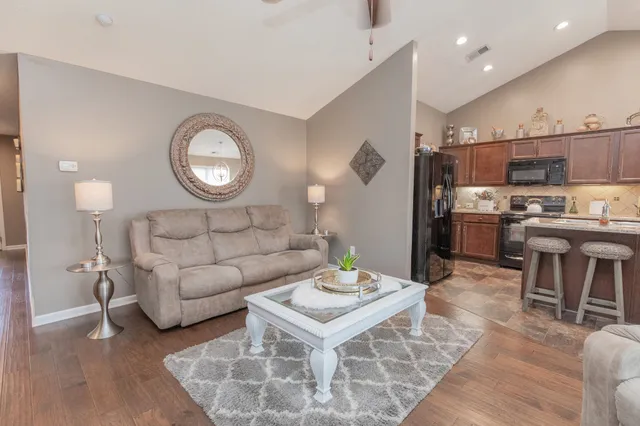 a living room with furniture a wooden floor and a fireplace