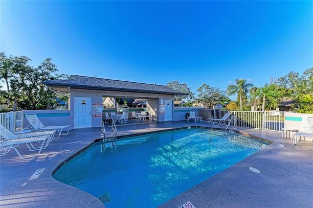 a view of a house with swimming pool yard and sitting area
