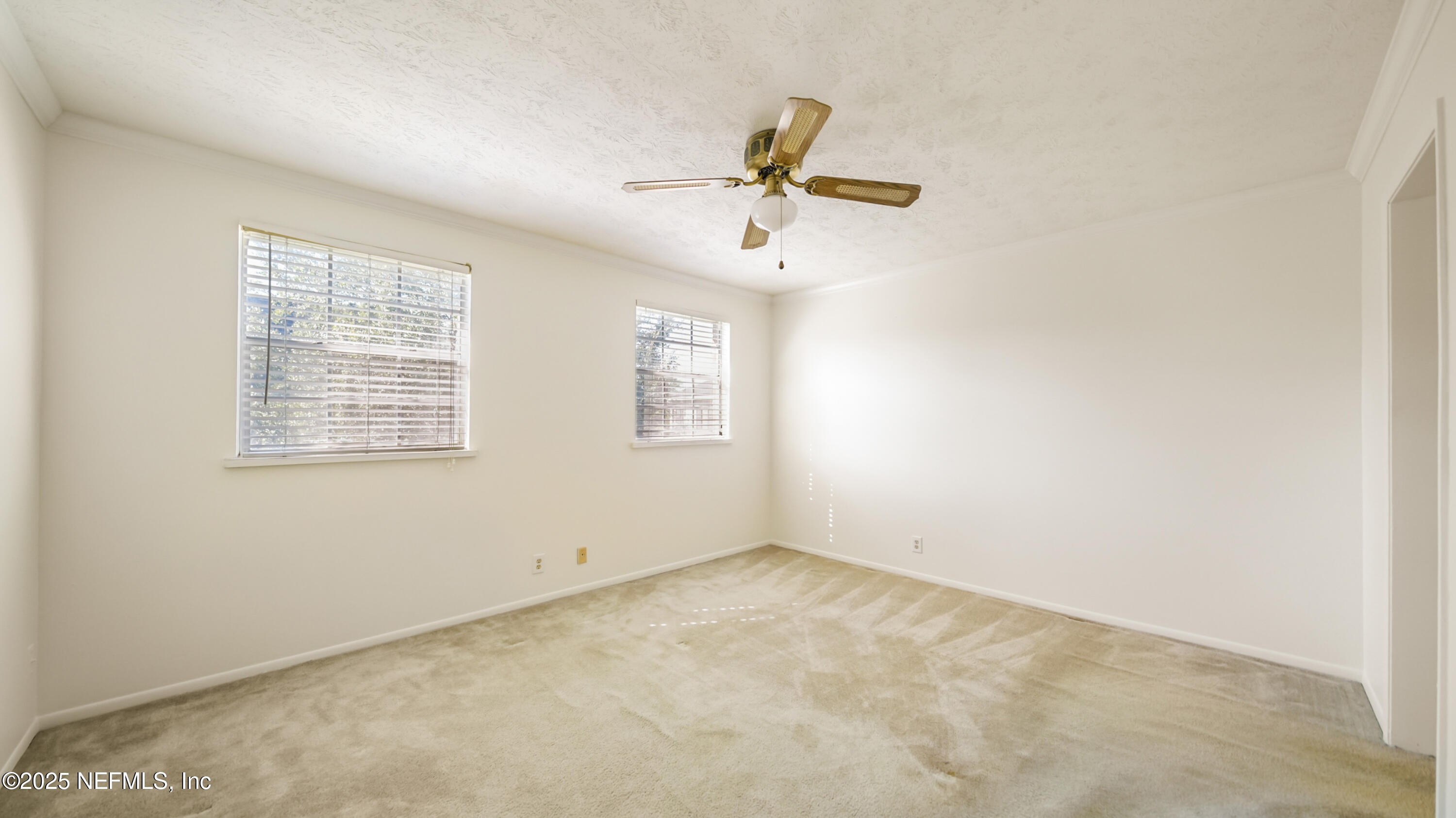 4915 Baymeadows Road, Unit 7H Jacksonville, FL 32217 - Photo 19 of 33 an empty room with windows and fan