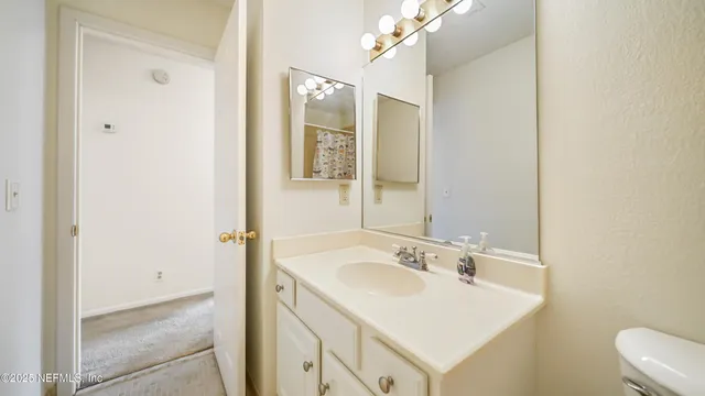 a bathroom with a sink vanity and a mirror