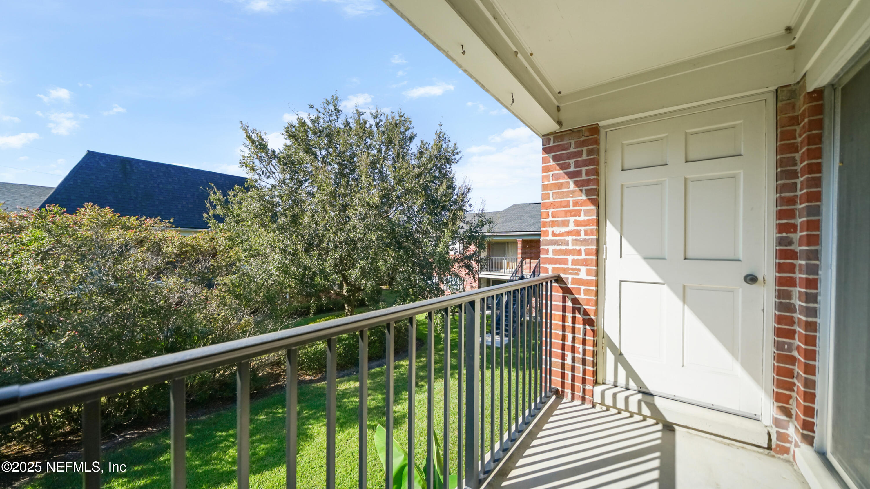 4915 Baymeadows Road, Unit 7H Jacksonville, FL 32217 - Photo 30 of 33 a view of a balcony with wooden floor and fence