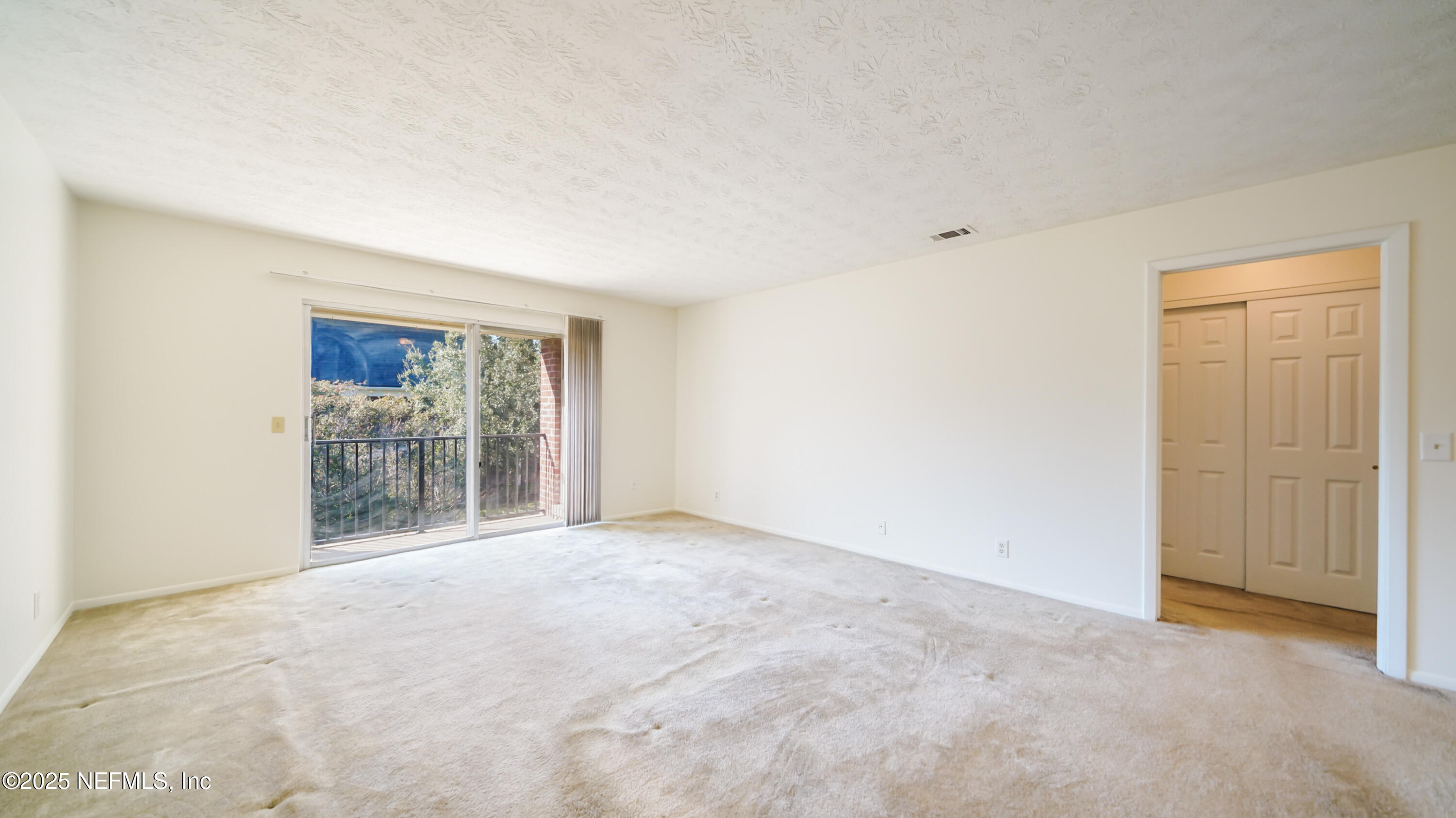 4915 Baymeadows Road, Unit 7H Jacksonville, FL 32217 - Photo 6 of 33 a view of an empty room with a window