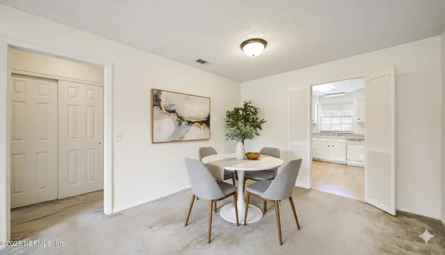 a dining room with furniture and window