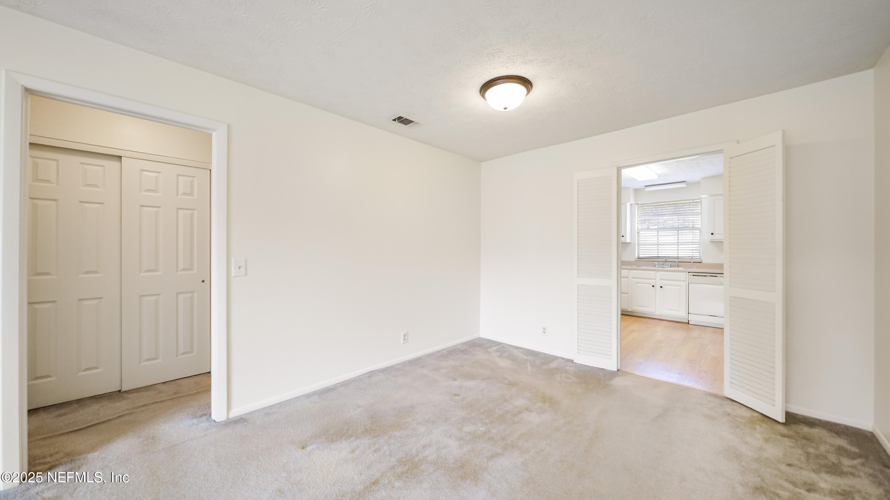 4915 Baymeadows Road, Unit 7H Jacksonville, FL 32217 - Photo 8 of 33 an empty room with a kitchen