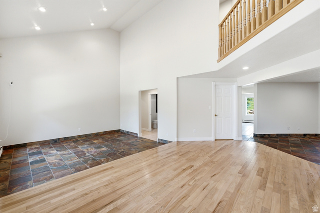 3535 Homestead Road Park City, UT 84098 - Photo 7 of 81 Spacious interior featuring a high vaulted ceiling, recessed lighting, and a combination of wood-finish flooring and large format slate tile