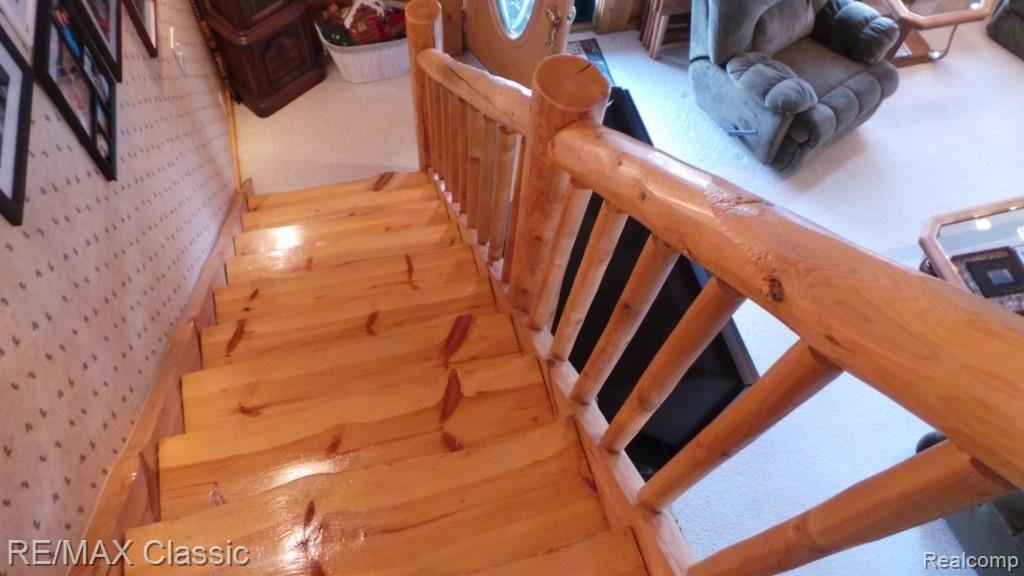 2447 North Hacker Road Howell, MI 48855 - Photo 34 of 62 Wood stairway to 2nd level