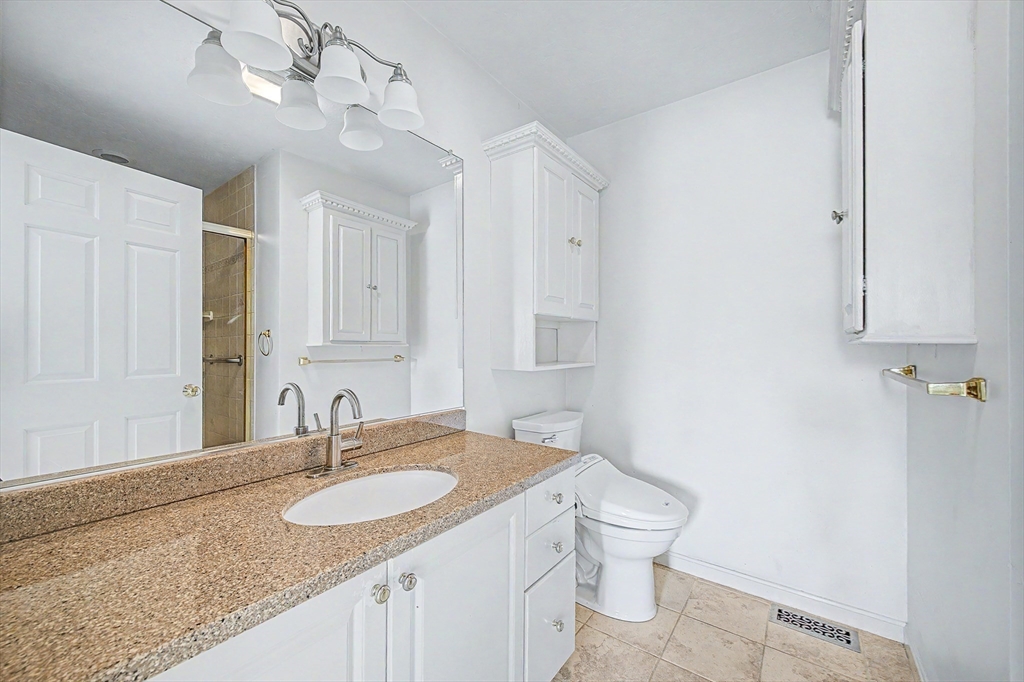 3 Oak View Terrace, Unit 3 Franklin, MA 02038 - Photo 14 of 38 a bathroom with a granite countertop sink a toilet and a mirror