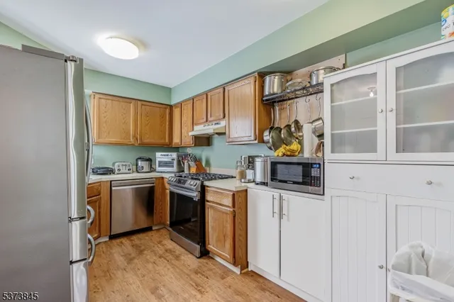 a kitchen with stainless steel appliances granite countertop a stove and a sink