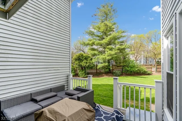 a view of a porch with furniture and garden