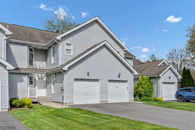 a front view of a house with a garden and yard