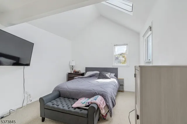 a bedroom with a bed and flat screen tv