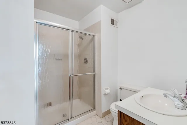 a bathroom with a shower and sink