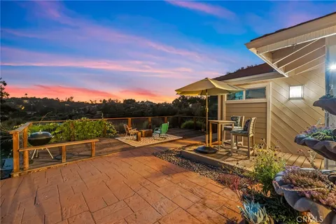 a view of a patio with a table and chairs