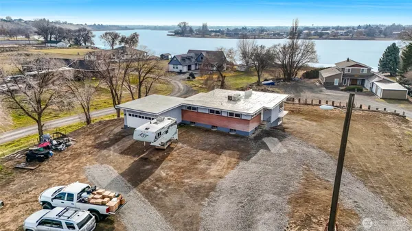 a view of a house with pool and chairs