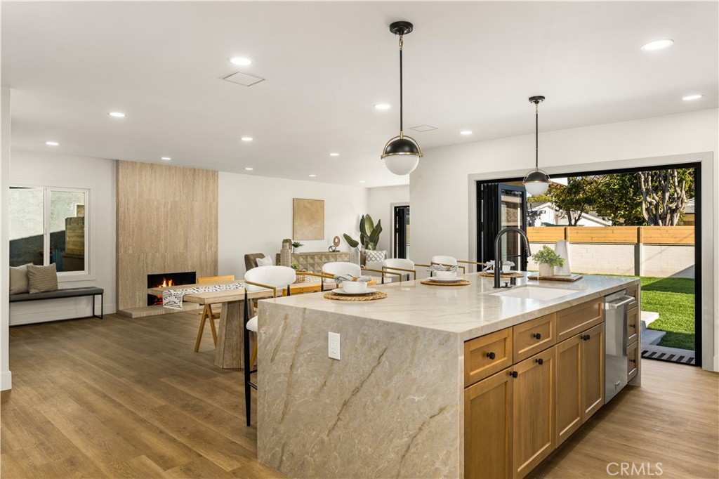 2440 Ostrom Avenue Long Beach, CA 90815 - Photo 12 of 50 a large kitchen with kitchen island a large counter top a sink appliances and living room view