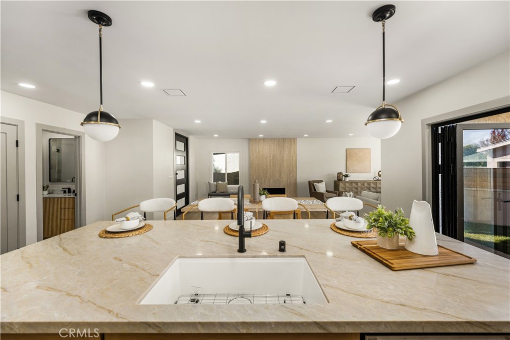 2440 Ostrom Avenue Long Beach, CA 90815 - Photo 13 of 50 a living room with furniture and a chandelier