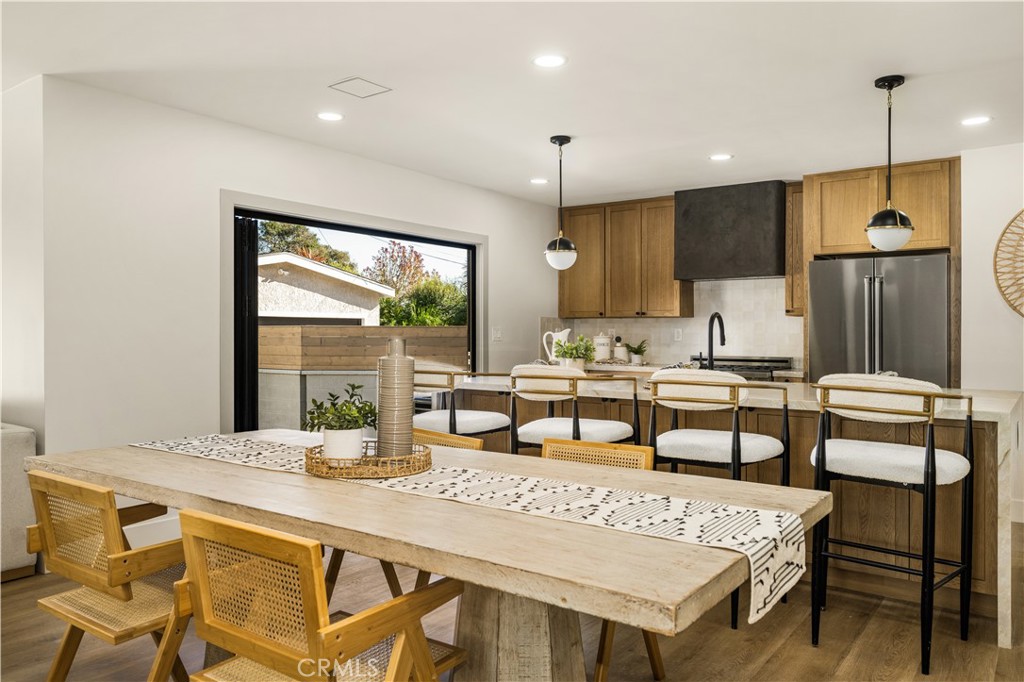 2440 Ostrom Avenue Long Beach, CA 90815 - Photo 22 of 50 a dining hall with stainless steel appliances kitchen island granite countertop a dining table chairs and granite counter tops