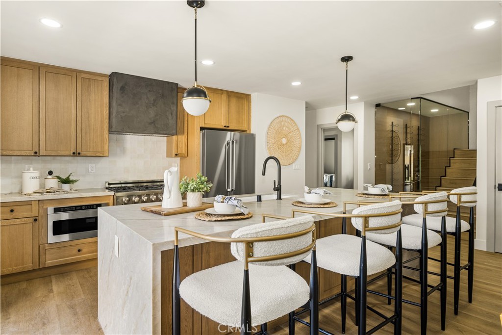 2440 Ostrom Avenue Long Beach, CA 90815 - Photo 24 of 50 a kitchen with a stove a sink a dining table and chairs