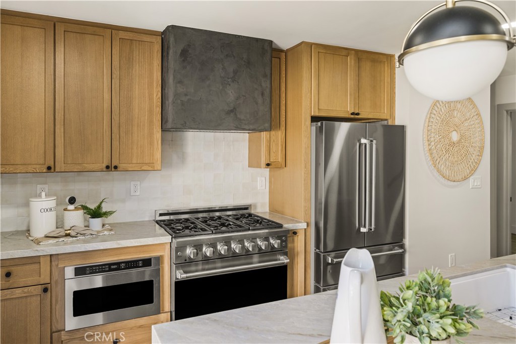 2440 Ostrom Avenue Long Beach, CA 90815 - Photo 26 of 50 a kitchen with stainless steel appliances a stove a refrigerator and a cabinets