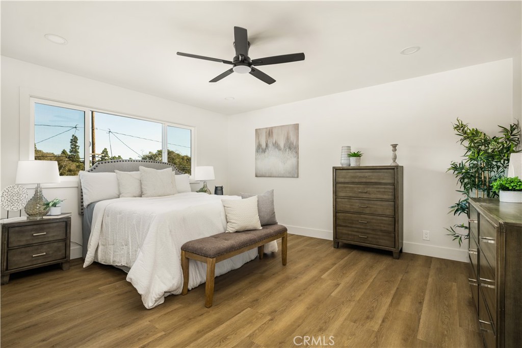 2440 Ostrom Avenue Long Beach, CA 90815 - Photo 43 of 50 a spacious bedroom with a bed table closet and a potted plant
