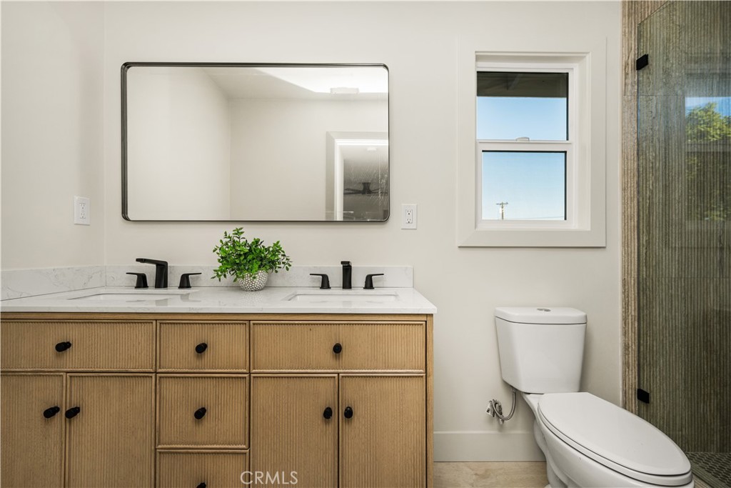 2440 Ostrom Avenue Long Beach, CA 90815 - Photo 46 of 50 a bathroom with a sink a toilet and mirror
