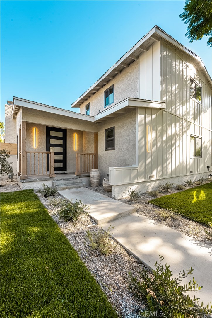2440 Ostrom Avenue Long Beach, CA 90815 - Photo 5 of 50 a front view of a house with a yard and garage