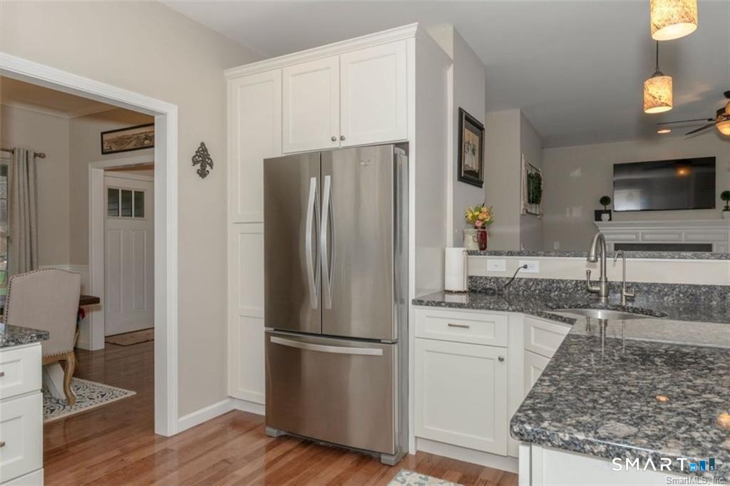 823 Stone Road Windsor, CT 06095 - Photo 15 of 38 a kitchen with granite countertop a refrigerator and a sink