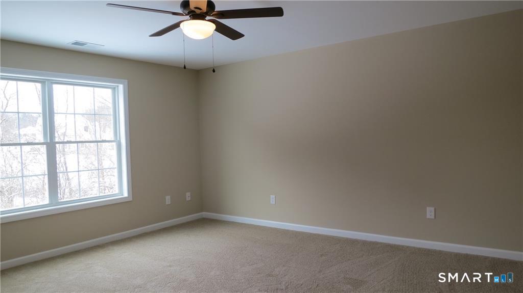 823 Stone Road Windsor, CT 06095 - Photo 31 of 38 an empty room with a window and a fan