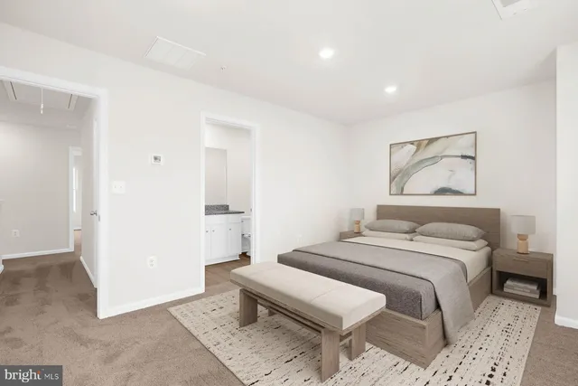 a bedroom with a bed and a painting