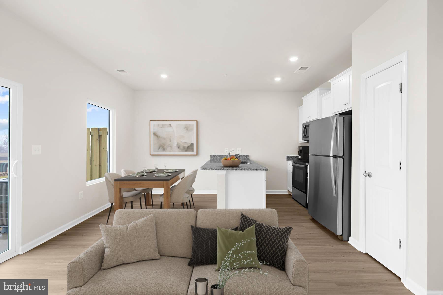 8128 Bartholomew Court Baltimore, MD 21206 - Photo 8 of 14 a living room with furniture a refrigerator and a table