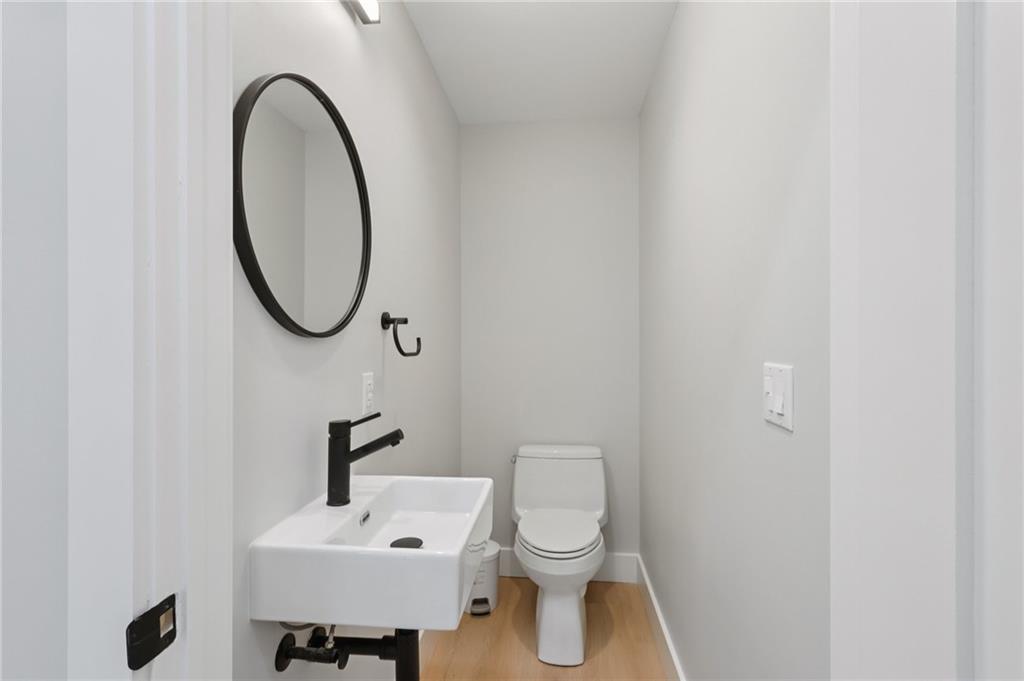 1211 Boyle Street Pittsburgh, PA 15212 - Photo 13 of 38 a bathroom with a toilet a sink and a mirror