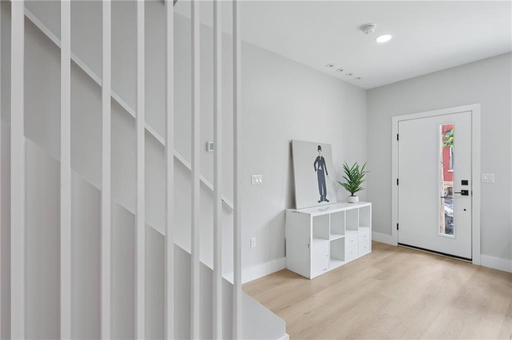 1211 Boyle Street Pittsburgh, PA 15212 - Photo 14 of 38 a view of a hallway with white walls and stairs