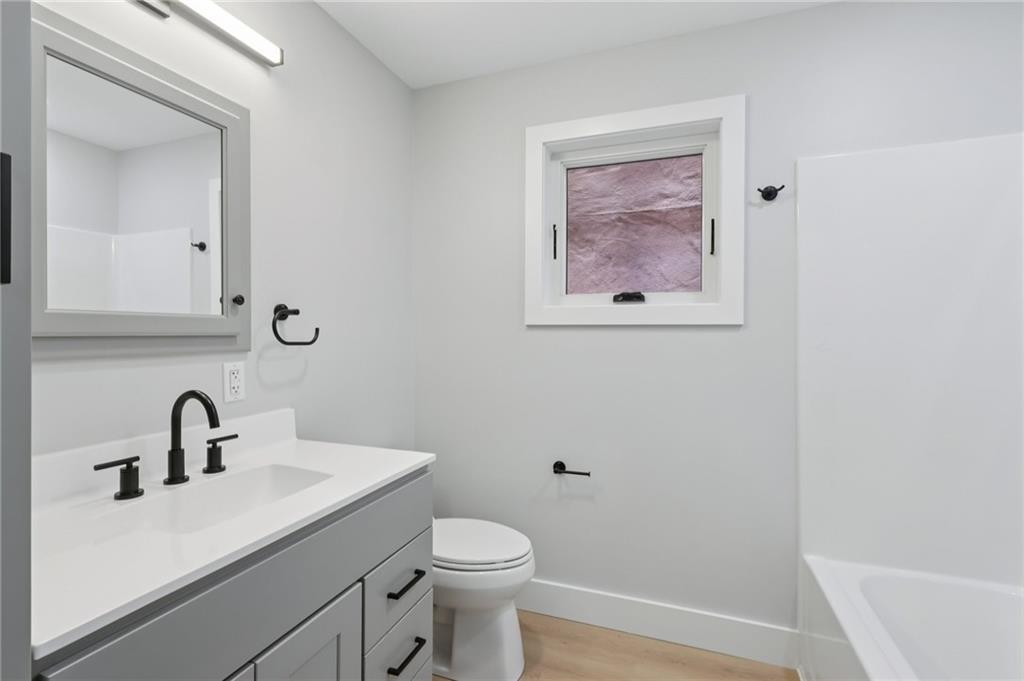 1211 Boyle Street Pittsburgh, PA 15212 - Photo 19 of 38 a bathroom with a toilet sink and mirror