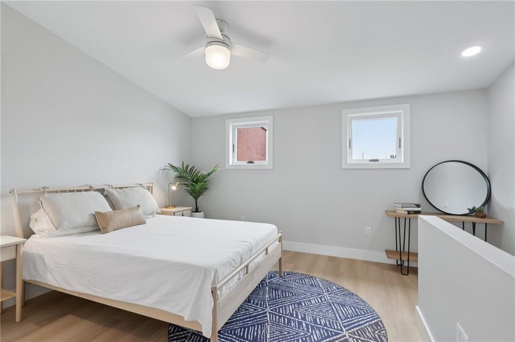 1211 Boyle Street Pittsburgh, PA 15212 - Photo 25 of 38 a bedroom with a bed and a chandelier