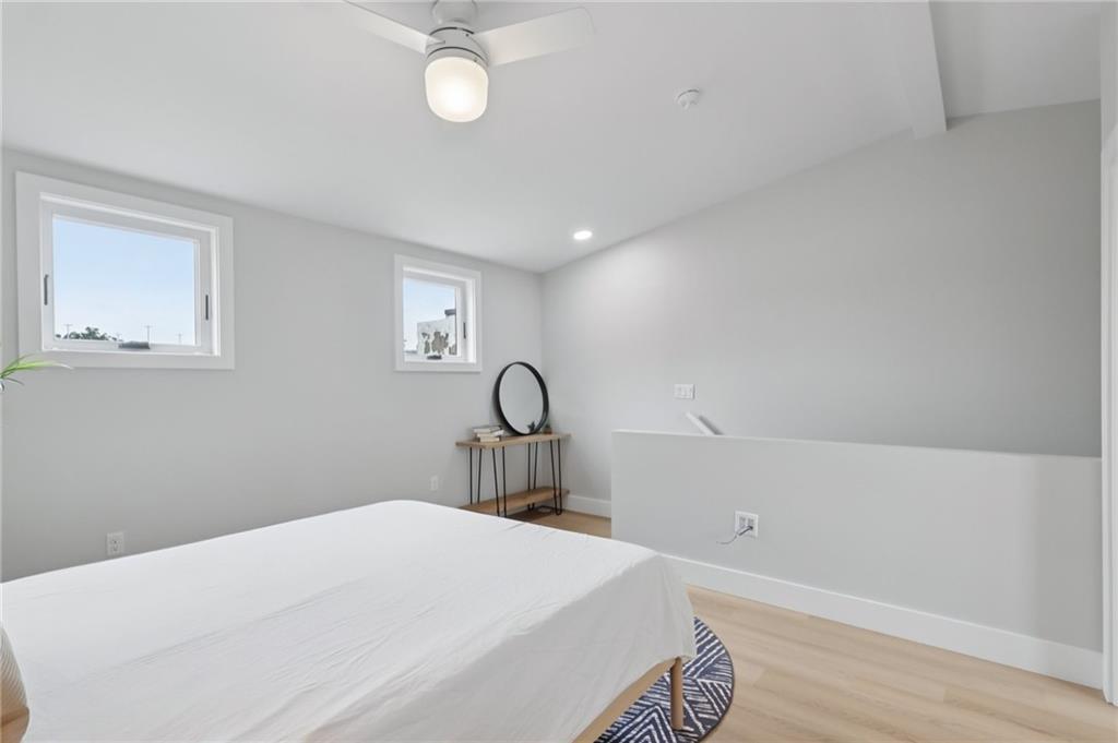 1211 Boyle Street Pittsburgh, PA 15212 - Photo 26 of 38 a bedroom with a bed and a chandelier