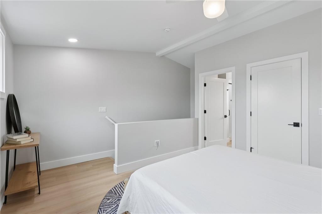 1211 Boyle Street Pittsburgh, PA 15212 - Photo 27 of 38 a bedroom with a bed and a chair