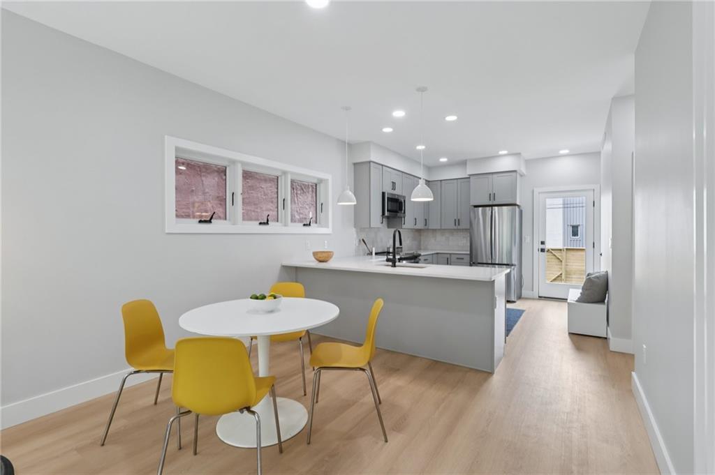 1211 Boyle Street Pittsburgh, PA 15212 - Photo 6 of 38 a kitchen with a table and chairs in it