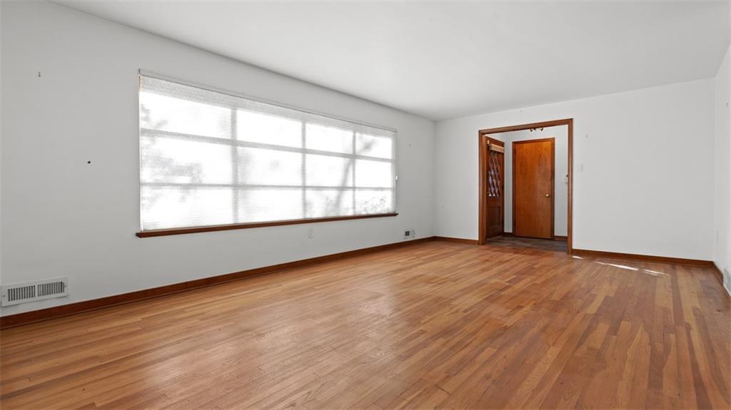 507 Rochester Road Rochester, PA 15074 - Photo 12 of 35 an empty room with wooden floor and windows