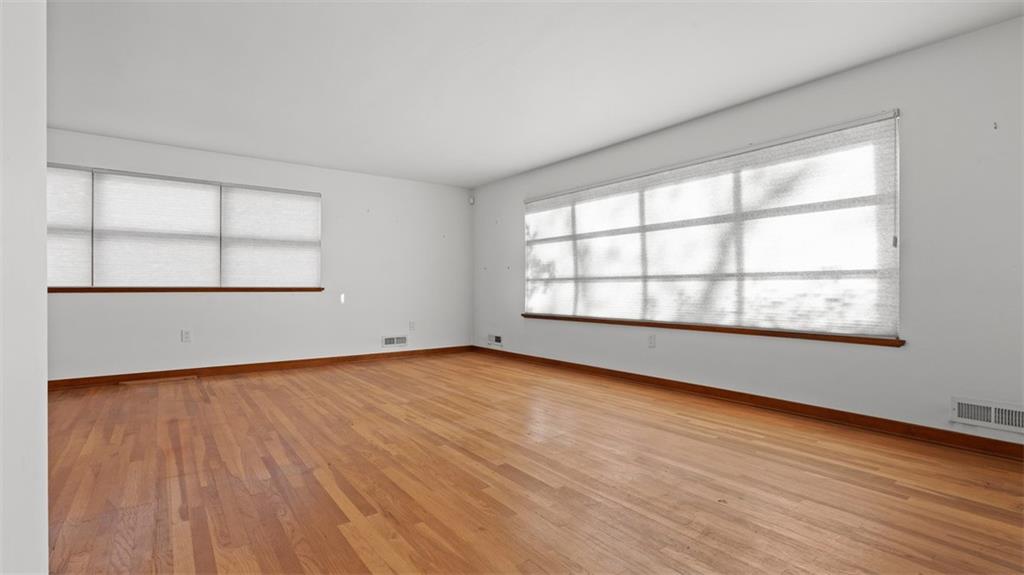507 Rochester Road Rochester, PA 15074 - Photo 13 of 35 an empty room with wooden floor and windows