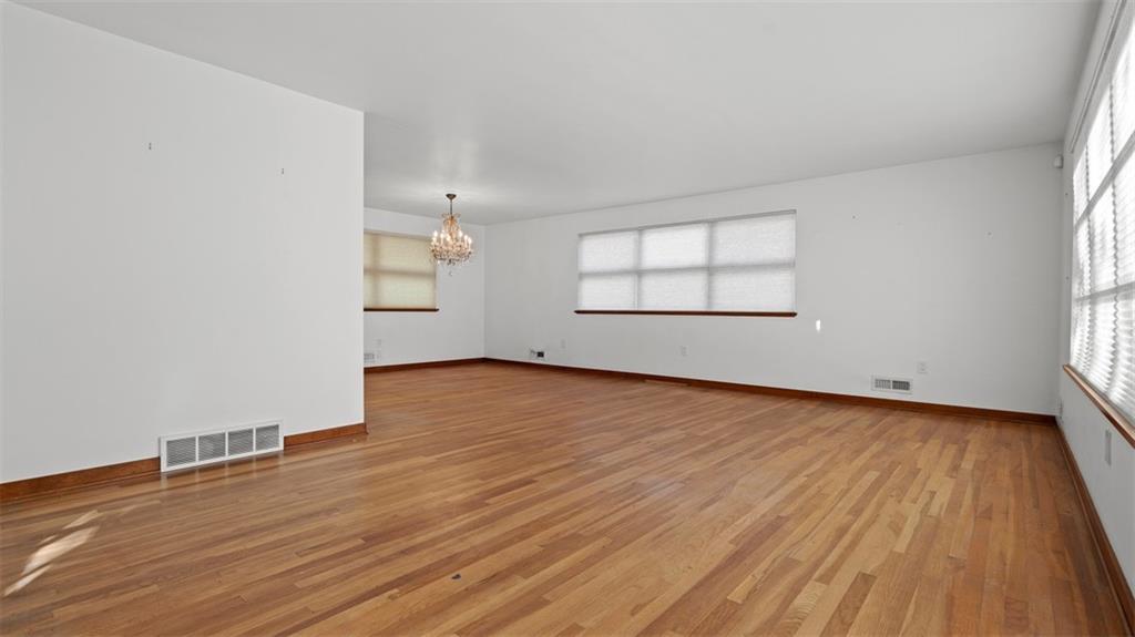 507 Rochester Road Rochester, PA 15074 - Photo 14 of 35 an empty room with wooden floor and windows