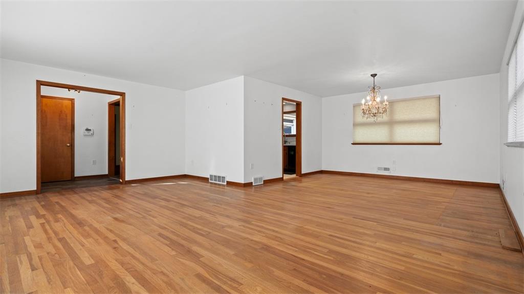 507 Rochester Road Rochester, PA 15074 - Photo 15 of 35 an empty room with window and wooden floor