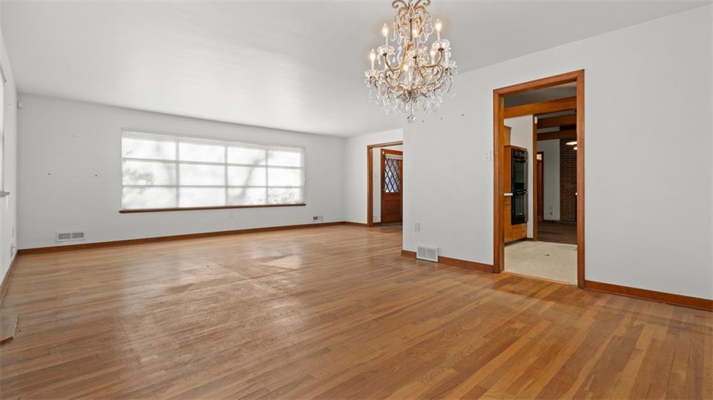 507 Rochester Road Rochester, PA 15074 - Photo 16 of 35 an empty room with chandelier fan and windows