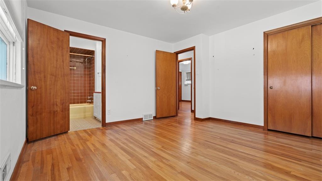 507 Rochester Road Rochester, PA 15074 - Photo 17 of 35 a view of an empty room with wooden floor and a window