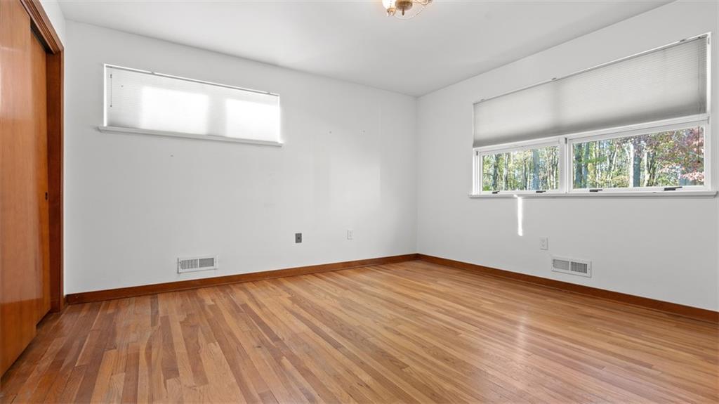 507 Rochester Road Rochester, PA 15074 - Photo 18 of 35 an empty room with wooden floor and windows
