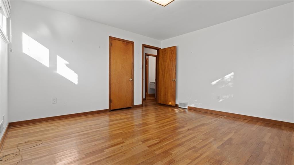 507 Rochester Road Rochester, PA 15074 - Photo 20 of 35 a view of an empty room with wooden floor and closet