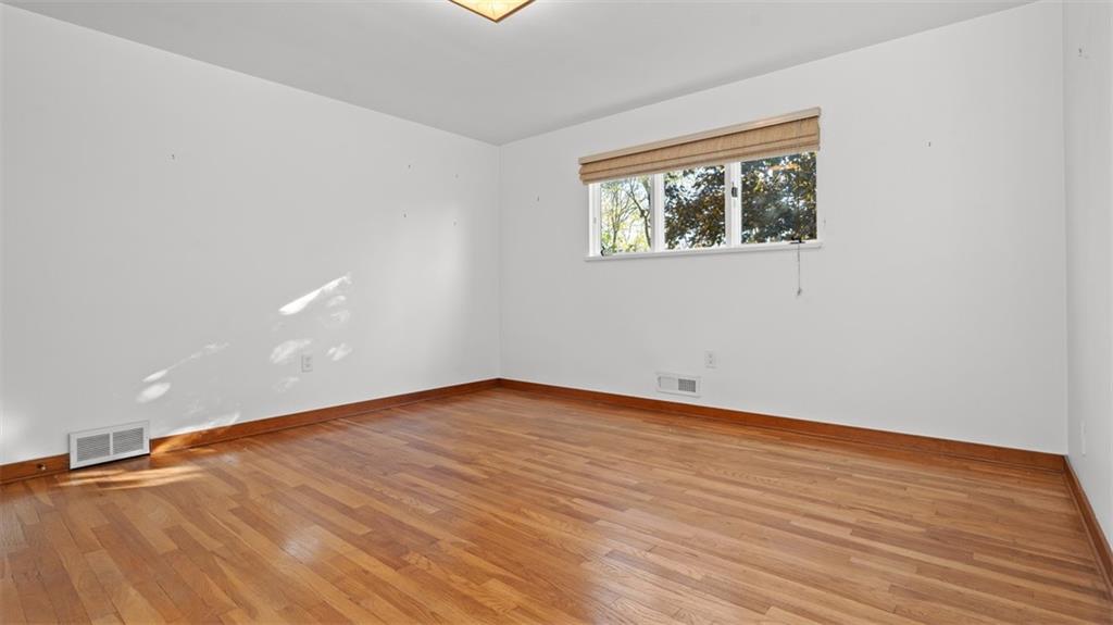 507 Rochester Road Rochester, PA 15074 - Photo 21 of 35 a view of an empty room with wooden floor and a window